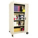 An Alera putty steel storage cabinet with shelves full of items.