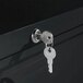 A key inserted in the lock of a black Alera metal lateral file cabinet.