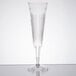 A clear plastic champagne flute with a long stem.