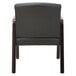 A black leather Alera reception arm chair with espresso wood frame.