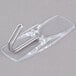 A 3M Command clear plastic wire toggle hook with a metal hook.