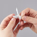 close-up of a person's hand holding a white tape