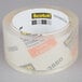 A roll of 3M Scotch clear packaging tape with labels.