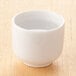 A white Town ceramic sake cup filled with liquid.