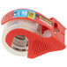 A roll of 3M Scotch heavy-duty packaging tape in a red tape dispenser.