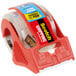 A roll of 3M Scotch heavy-duty packaging tape in a red and clear dispenser.