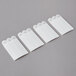 A row of white 3M Command large picture hanging strips.