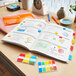 3M Post-It assorted color tabs on a notebook.