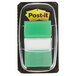 a green and white post-it note in a package