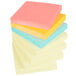 A stack of 14 Post-It note pads with yellow and neon colored paper on top.