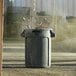 A close-up of a grey Rubbermaid Brute trash can.