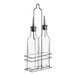 A set of two clear glass oil and vinegar cruet bottles with metal pour spouts, held in a metal rack.