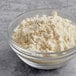 A bowl of 5 lb. Premium Biscuit Mix powder on a table.