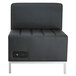 A black armless sectional with a power outlet.