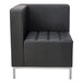 A black leather sectional corner chair with silver legs.