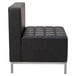 A black armless Alera QUB sectional chair with silver legs.