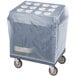 A slate blue plastic covered box on a Cambro cart with a white cover.