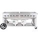 A large stainless steel Crown Verity outdoor grill with two horizontal propane tanks.