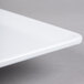 A white rectangular melamine serving platter with a handle.