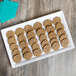 An Elite Global Solutions white rectangular melamine serving platter with cookies on it.