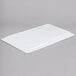 A white rectangular Elite Global Solutions melamine serving platter on a gray surface.