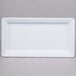 A white rectangular melamine serving platter with a white rim.