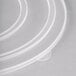 A stack of clear plastic Fineline catering bowl lids.