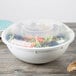 A close up of a white Fineline high profile plastic catering bowl filled with salad.