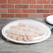 A clear plastic catering bowl lid with food inside.