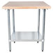 An Advance Tabco wood top work table with a galvanized base and undershelf.