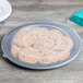 A Fineline black plastic catering tray holding cookies on a table.