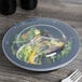 A salad in a Fineline black low profile plastic serving bowl.