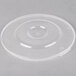 A clear plastic lid with a circular hole on a white surface.