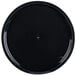 a black round plate with a drop of water in the middle