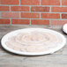 A clear plastic catering bowl lid on a table of cookies.