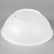 A white bowl with a round lid on a gray background.