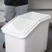 The front and back of a white plastic container lid.