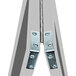 A close-up of metal hinges on a white surface.