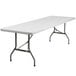 A Flash Furniture white rectangular folding table with metal legs.