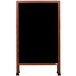 A wooden A-frame sign board with a black write-on board.