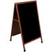 A cherry wood A-Frame sign board with a black write-on board.