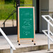 An oak A-Frame chalkboard sign outside an organic food store.