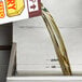 A person pouring Admiration Pro Fry Liquid Shortening into a container.