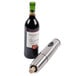 A silver Waring wine bottle opener next to a wine bottle.