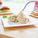 A Eco-Products white compostable plate with a burrito on it.