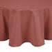 A mauve Intedge round tablecloth with a white hem on a table.