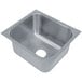 An Advance Tabco stainless steel undermount sink bowl with a square hole.