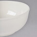 A white Thunder Group melamine pho noodle bowl with a white rim on a gray surface.