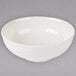 A white Thunder Group melamine Pho noodle bowl with a white rim on a gray surface.