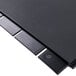 A black rectangular surface with four black plastic strips.
